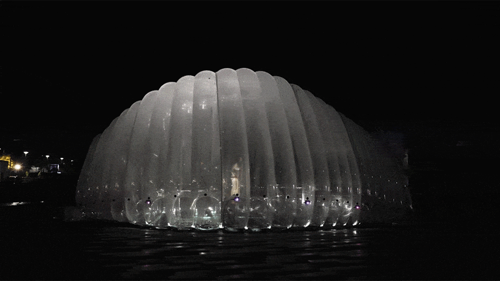Woman bounces inside AirBubble in Glasgow at night